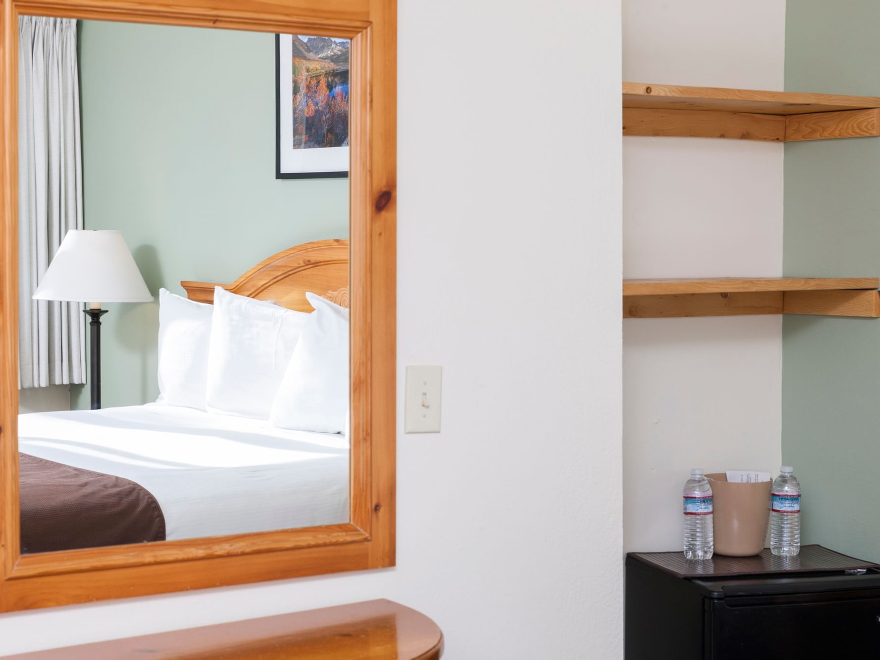 Mirror on wall next to shelves in King Room at Alpenhof Lodge