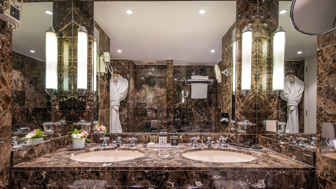 Warwick Suite bathroom featuring a marble vanity with a mirror at Warwick Grand Place Brussels 