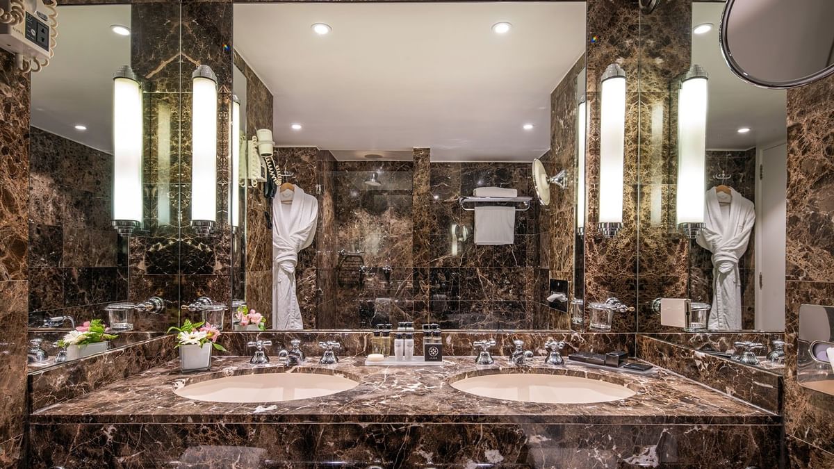 Warwick Suite bathroom featuring a marble vanity with a mirror at Warwick Grand Place Brussels 