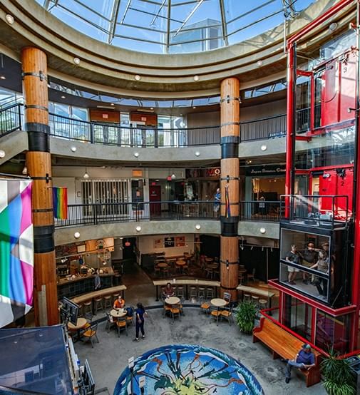 Lonsdale Quay Market with a circular floor design, surrounded by a two-story rotunda near Coast Lonsdale Quay Hotel