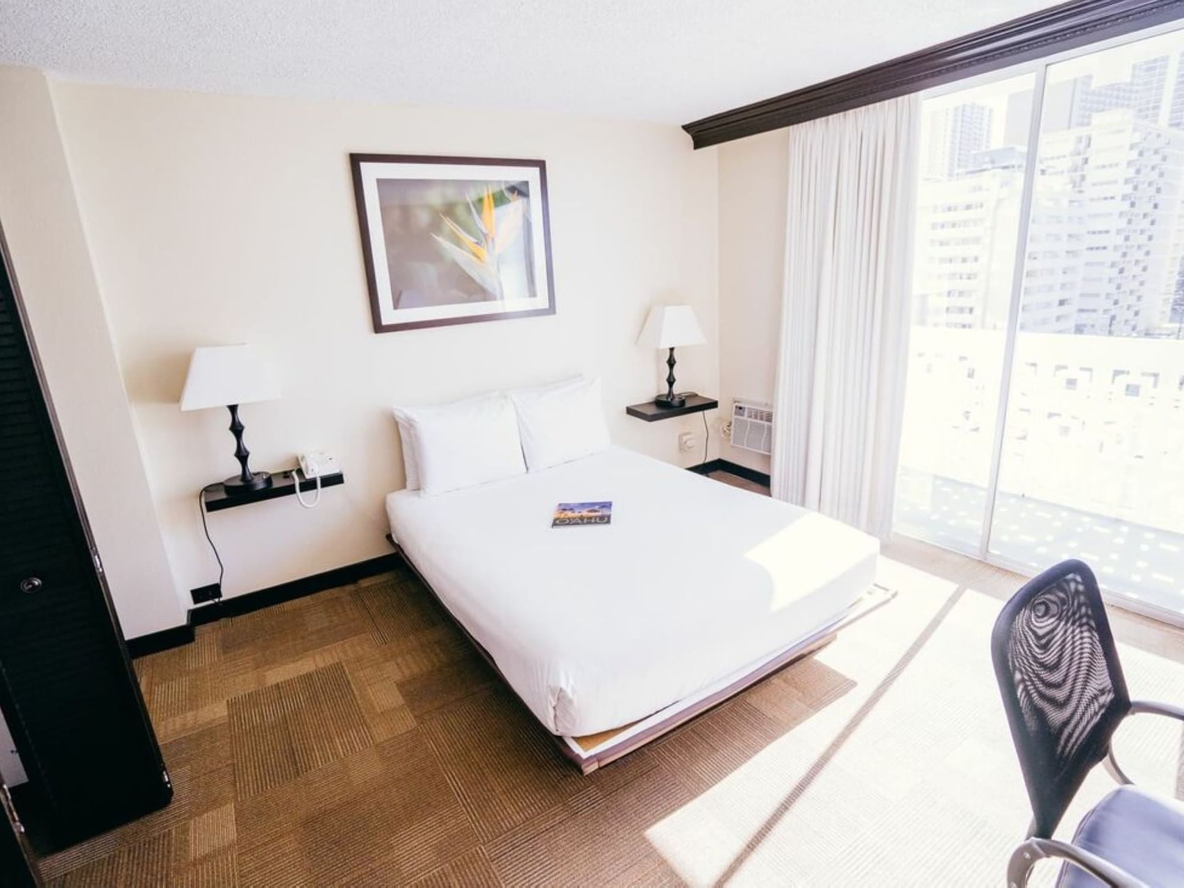 A bed, chair & lamps in Boutique Queen at Stay Hotel Waikiki