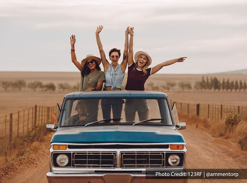 friends posing picture and creating memories on the road trip