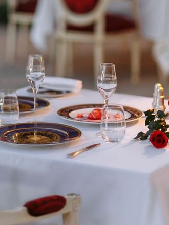 Close-up of dining table setup with roses at Palazzo Versace 