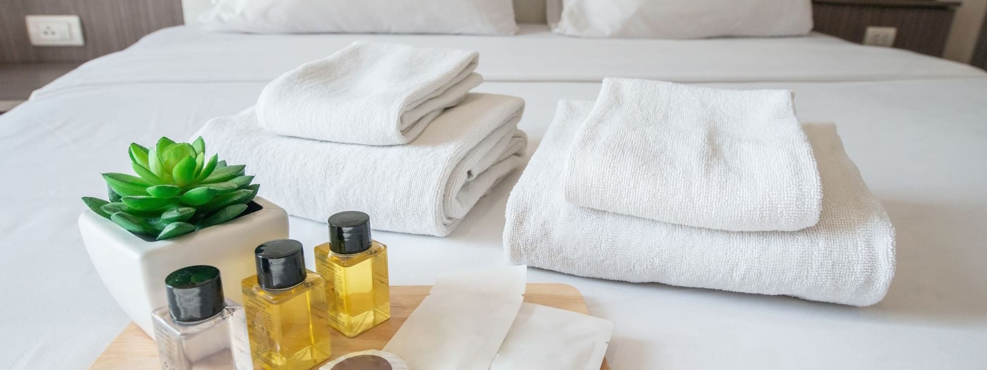 Toiletries and towels on bed at Daydream Island Resort