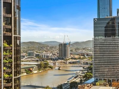 Elevated view of Brisbane River and cityscape with bridges and modern buildings at UniLodge Brisbane City.