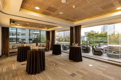 High-top tables & glass doors leading to an outdoor terrace highlighting vina del mar meeting room at Veranda Hotel