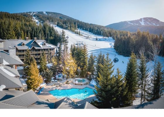 Aerial view of Blackcomb Springs Suites & outdoor pool with skiing slopes