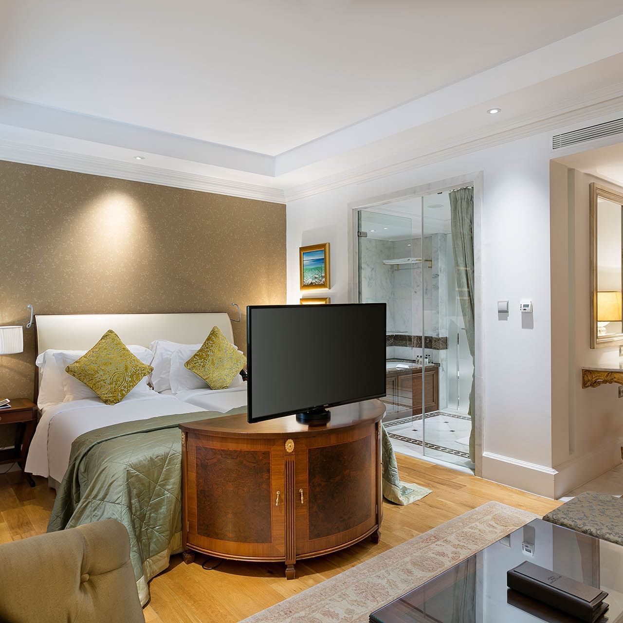 Cozy bed and TV in Premium Sea/Pool View Room at Titanic Mardan Palace