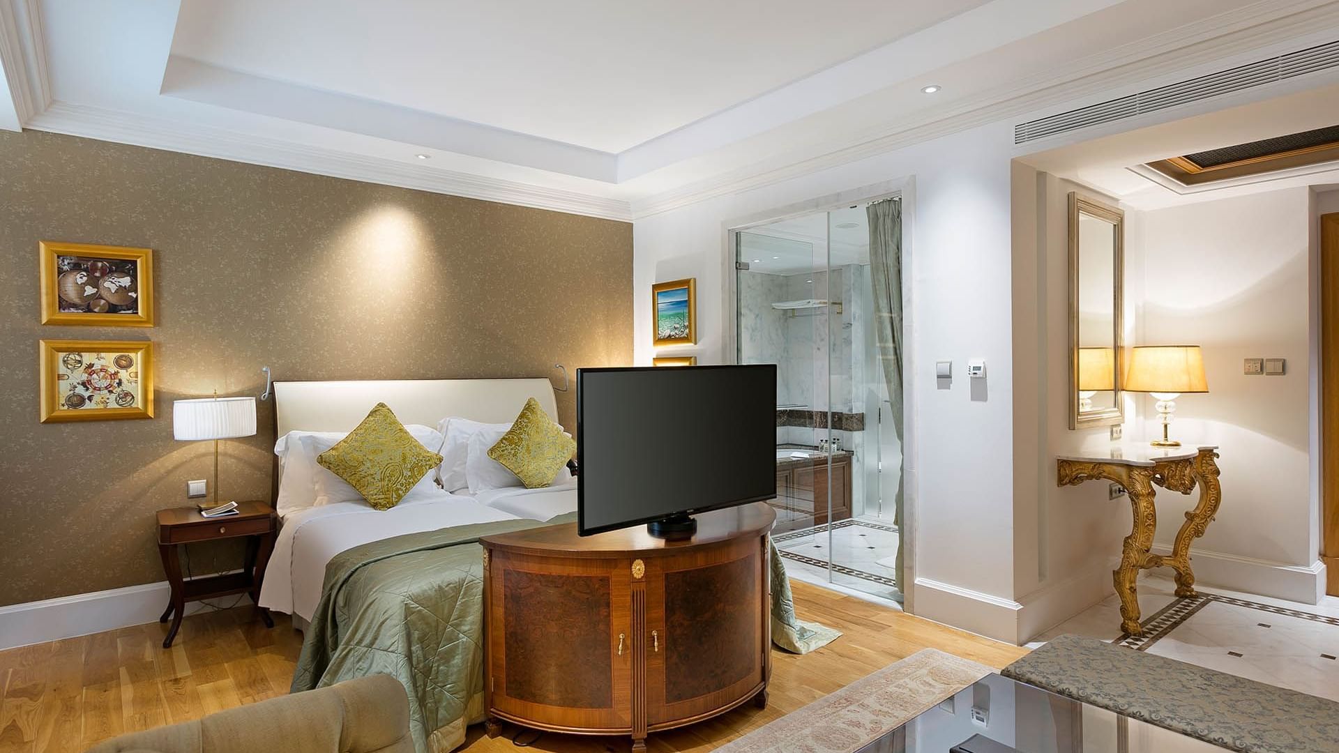 Cozy bed and TV in Premium Sea/Pool View Room at Titanic Mardan Palace