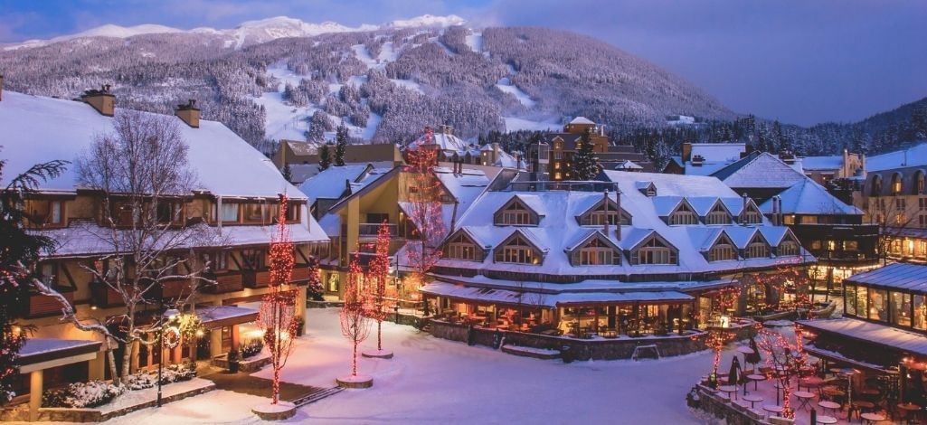 January in Whistler village at dusk with lights snow and mountain views.