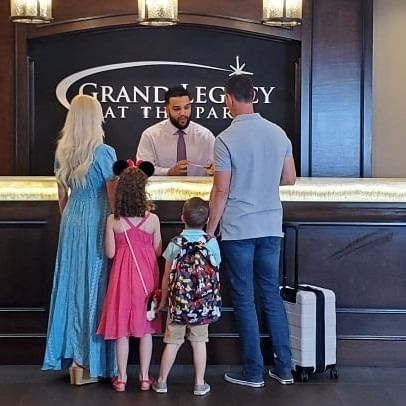 Family with Suitcases Checking into Hotel