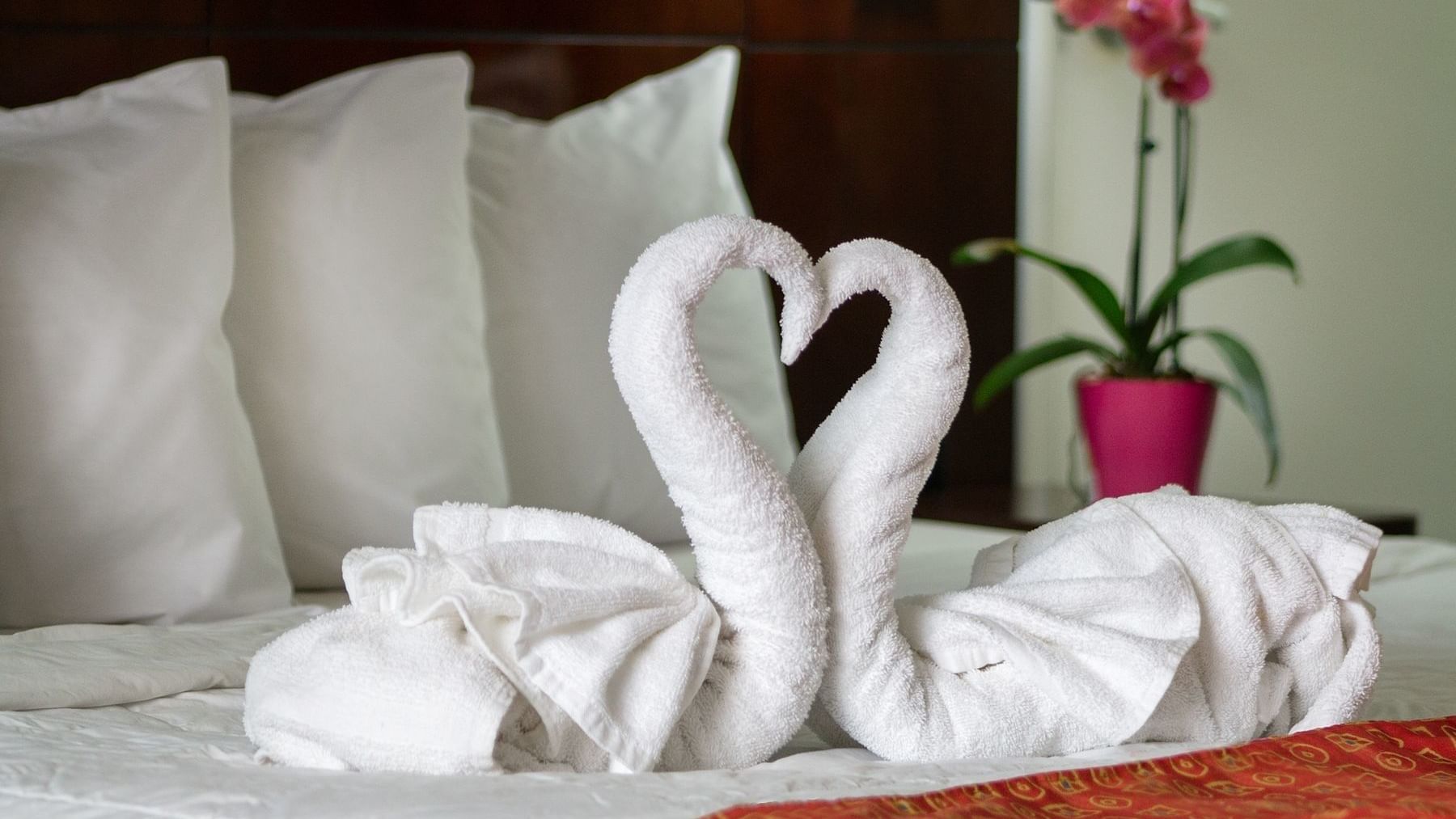 Towel arrangement on the bed in standard suite at DOT Hotels