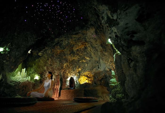 Lady meditating in the Treatment Caves at The Banjaran Hotsprings Retreat