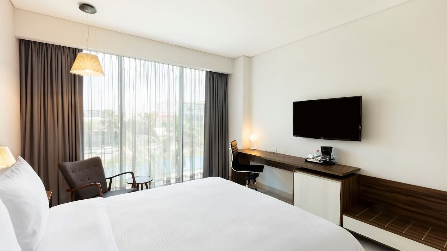 Superior Room at Fiesta Inn Express Cancún Cumbres with a TV mounted above a desk by a window, accommodations in Cancun