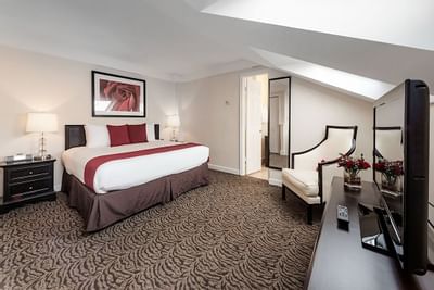 King bed in a room with a large rose painting at Artmore Hotel
