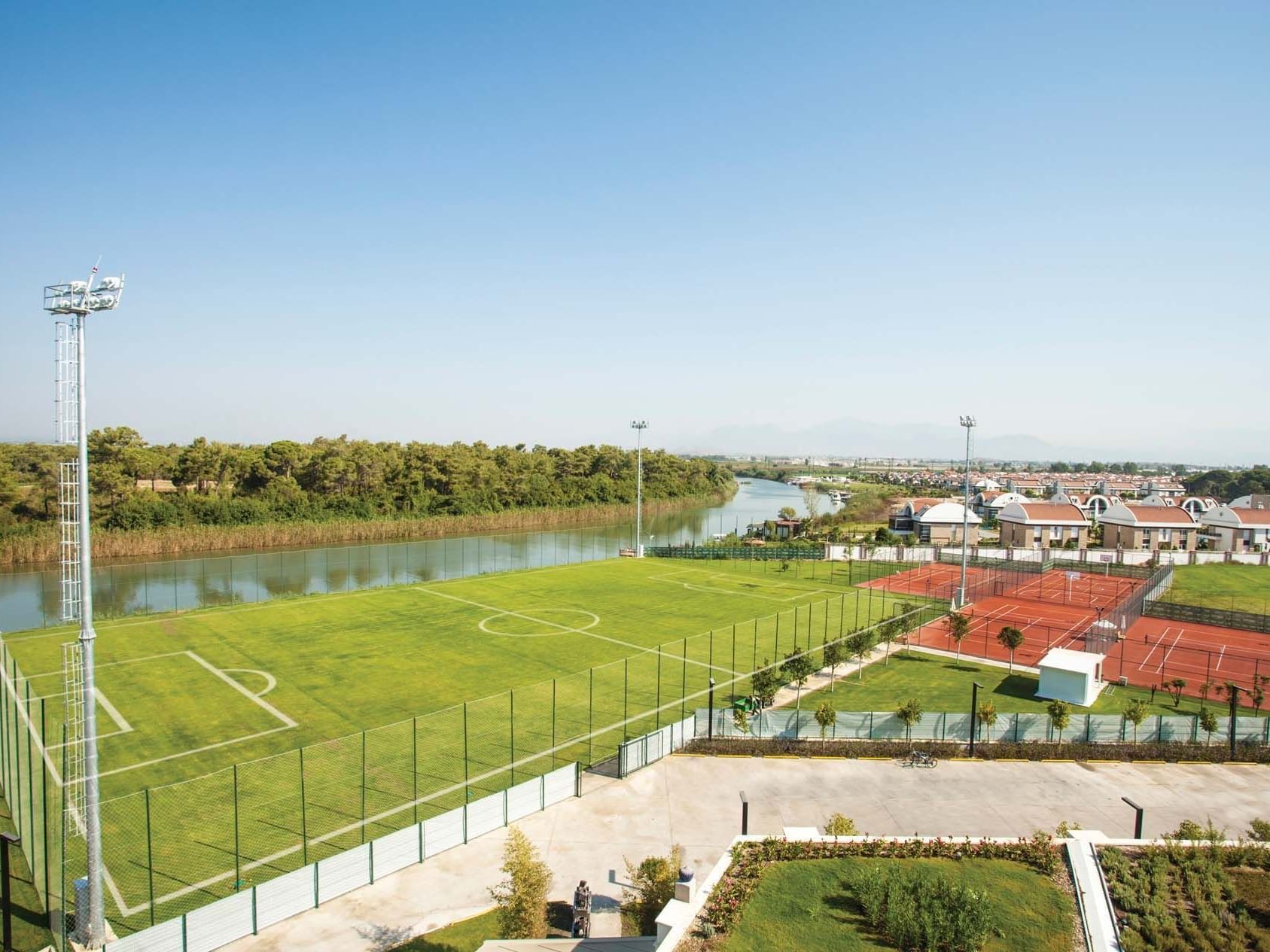 Aerial view of tennis court and soccer field near Titanic Deluxe Golf Belek