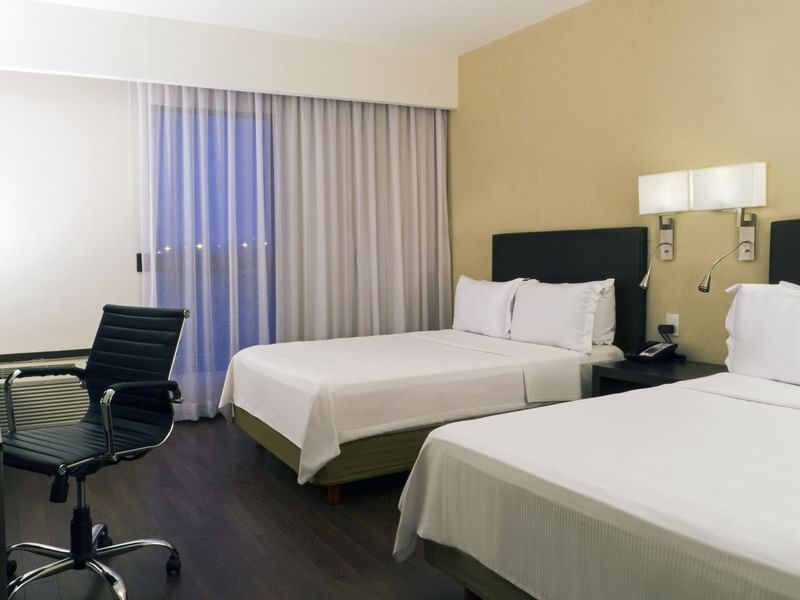 Twin beds in Superior Room with working desk at Fiesta Inn