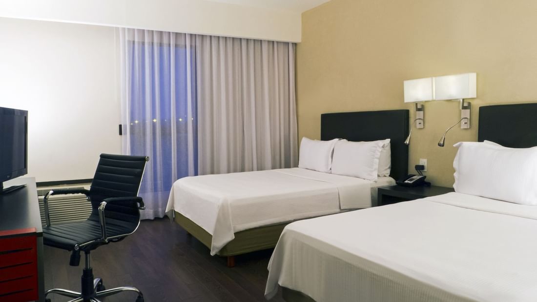 Twin beds in Superior Room with working desk at Fiesta Inn