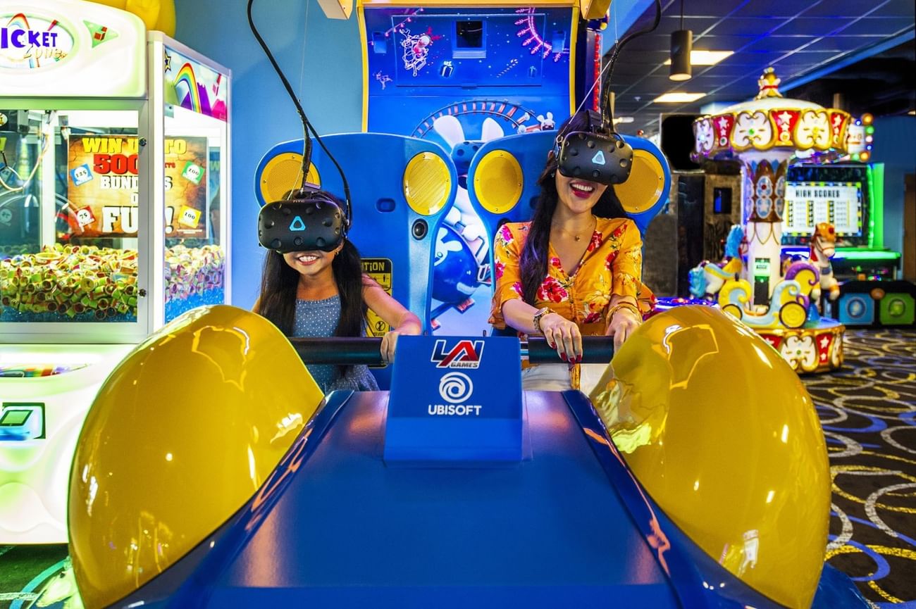 Two kids at an arcade game in Flip Flop's Family Center at The Grove Resort & Water Park