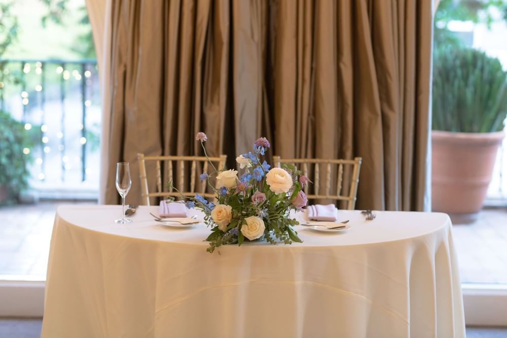 Elegantly set table with a beautiful floral centerpiece at El Prado Hotel 