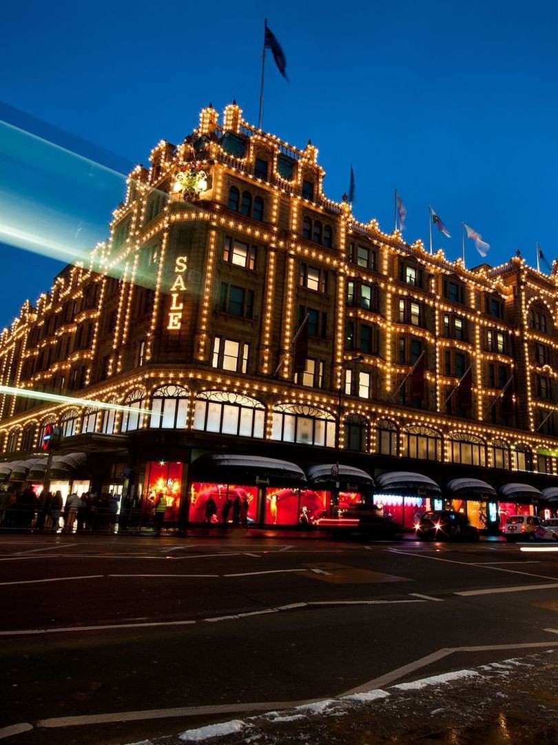 Night view of the department store illuminated by lights, with light trails near Warwick Hotels & Resorts