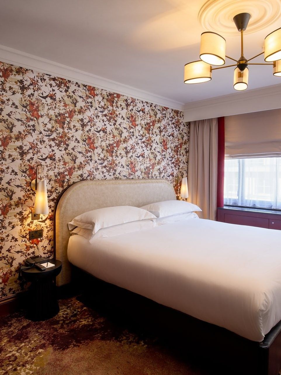 Bed with side table near the window in Superior King Twin bedroom at The Capital Hotel, Apartments and Townhouse