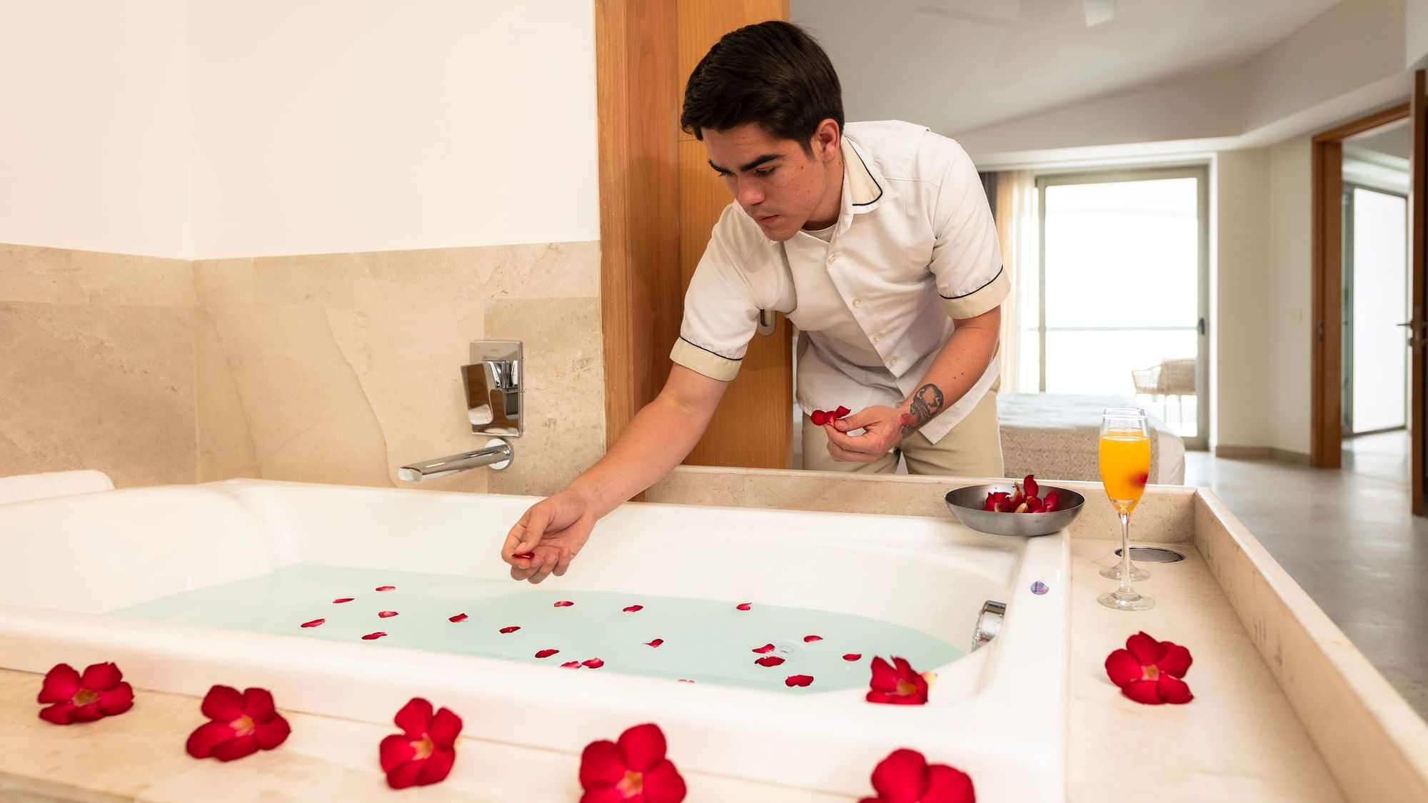 Staff preparing a romantic bath in the Premium Suite at Sunset Plaza Beach Resort, one of the top Puerto Vallarta hotels