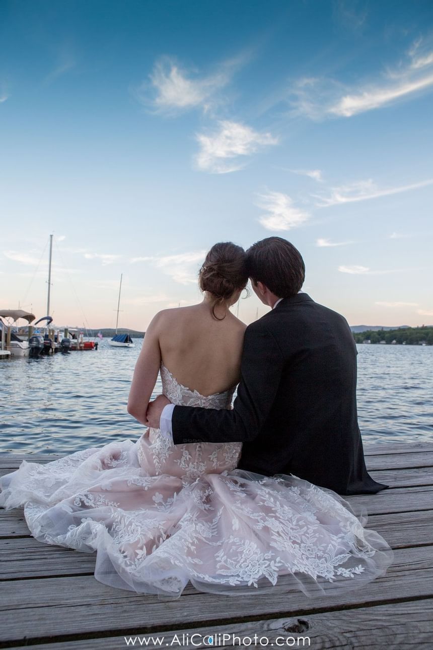 Bride and groom sitting on a deck  at Wolfeboro Inn