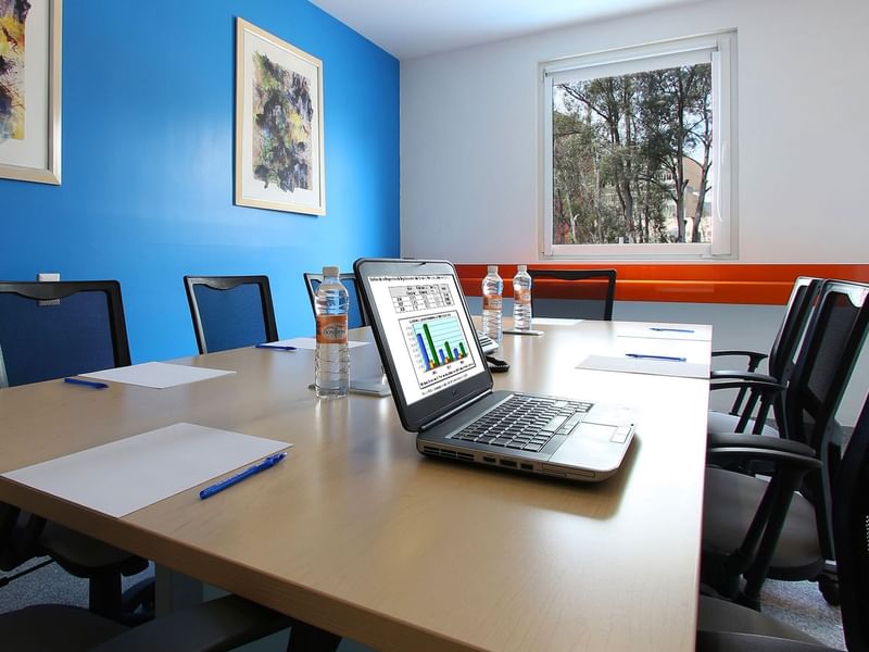 Conference table with a laptop in a Meeting Room at One Hotels