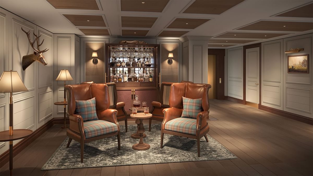 Bar with leather chairs, wood floors, and deer head decor at Seaton House