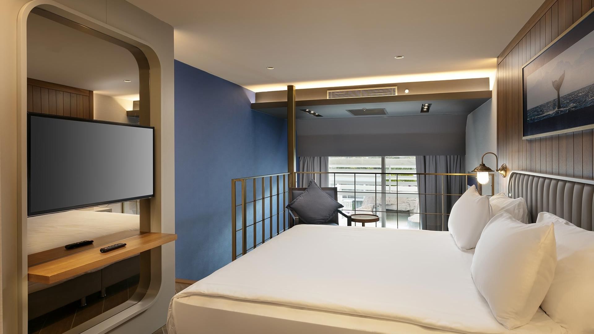 Современный номер в Titanic Deluxe Lara – Annex Duplex Suite с голубыми стенами, большой кроватью и плоским экраном телевизора.