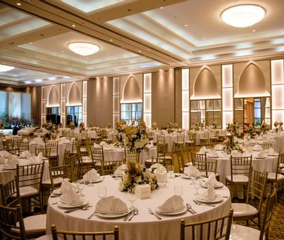 Banquet tables arranged in a Hall for an event at Ajman Hotel