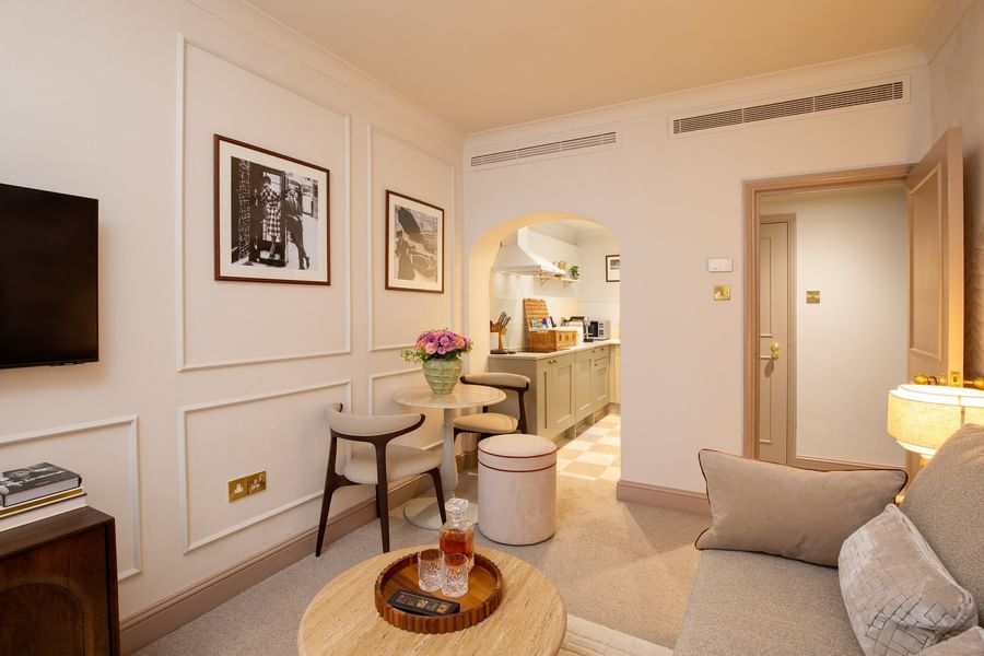 One Bedroom Apartment living with sofa & a dining table near the kitchenette at The Capital Hotel, Apartments and Townhouse