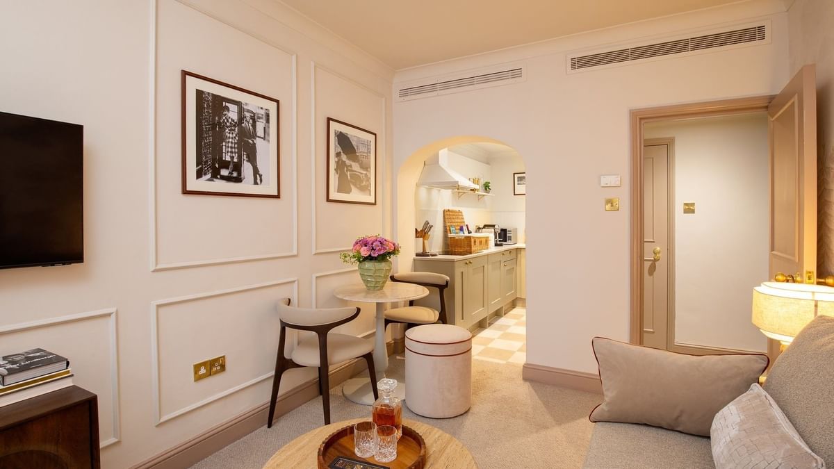 One Bedroom Apartment living with sofa & a dining table near the kitchenette at The Capital Hotel, Apartments and Townhouse