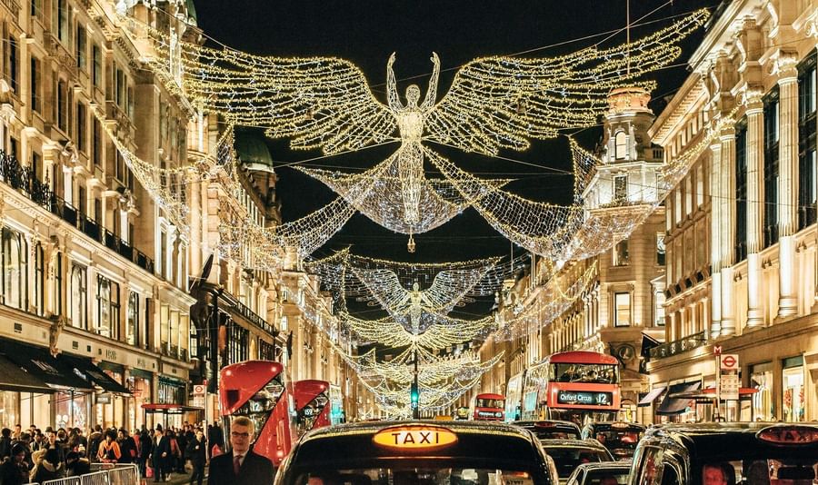 Regent Street in London illuminated with angel figure made of festive lights for Christmas near The May Fair Hotel