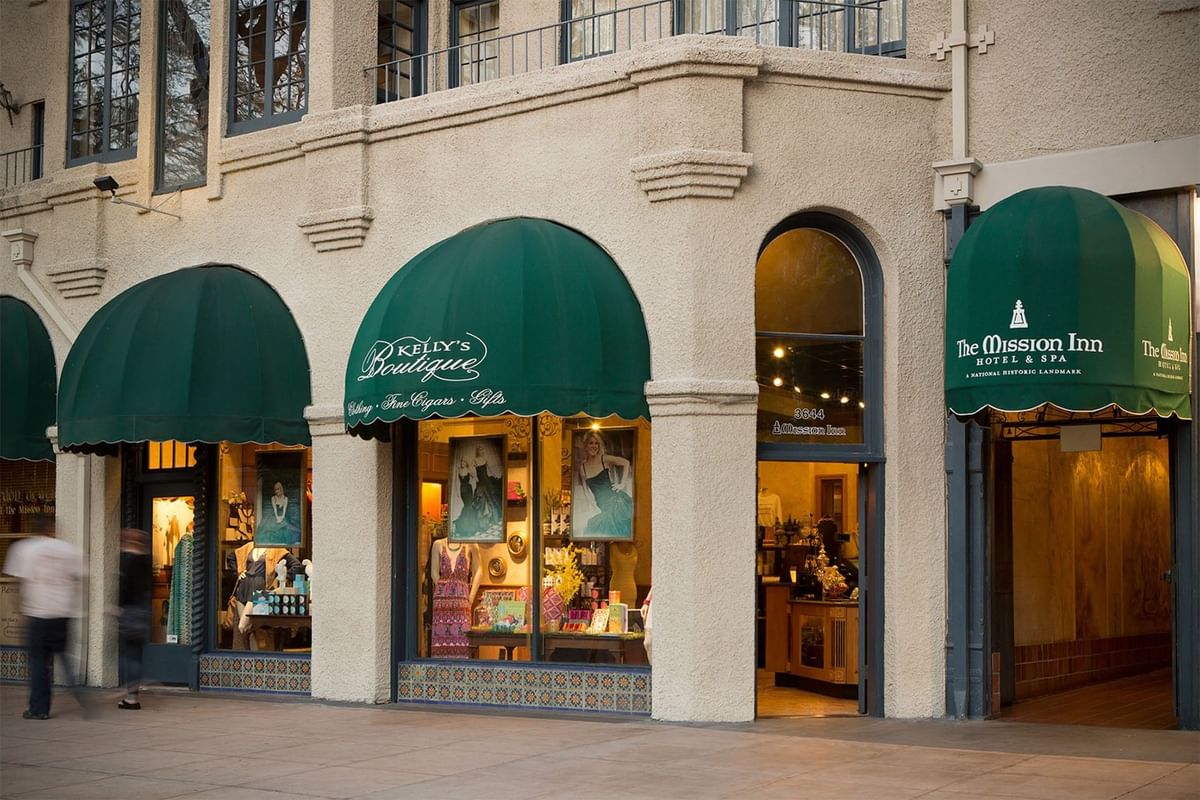 Storefront featuring a green awning, inviting customers with its vibrant color and welcoming appearance at Kelly's Spa