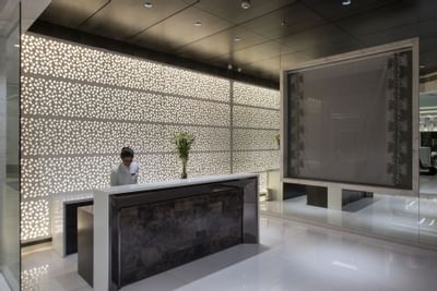 Receptionist by the front desk at Eastin Residences Vadodara