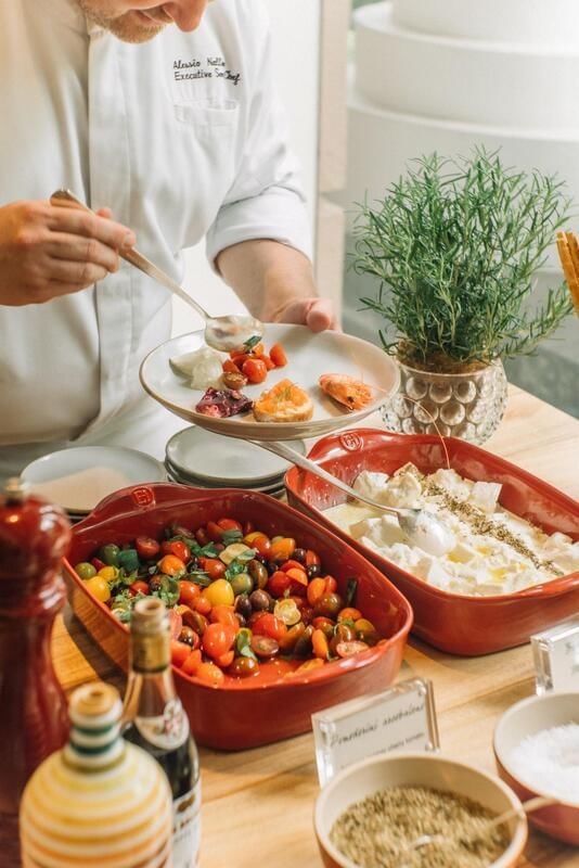 Chef carefully plating colorful appetizers from a vibrant Opera Sunday Brunch at Park Hyatt Saigon