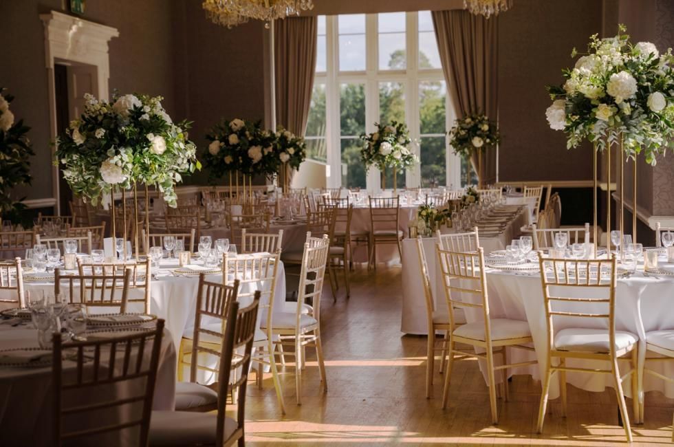 Floral wedding breakfast tables in the Downshire Ballroom