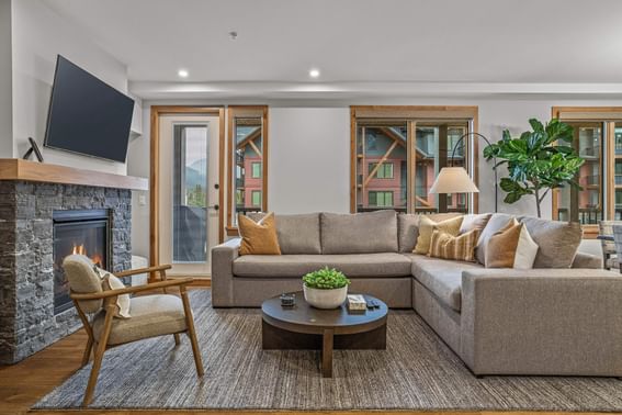 Living room with a sofa, armchair and fireplace in 213 Timberstone Lodge Three Bedroom Premier Condo at Spring Creek Vacation