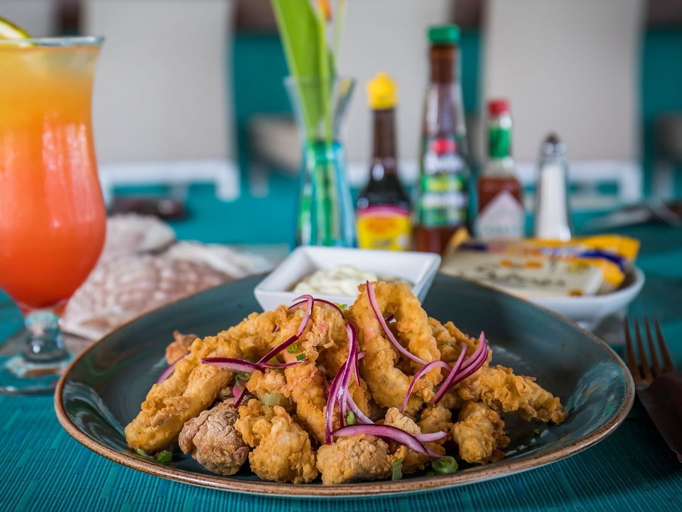 Fried cuttlefish dish with a cocktail in Acua at Palacio Mundo