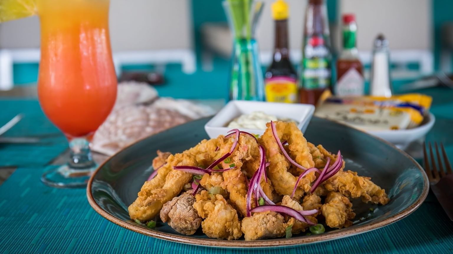 Fried cuttlefish dish with a cocktail in Acua at Palacio Mundo