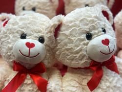 four white teddy bears smiling with red nose