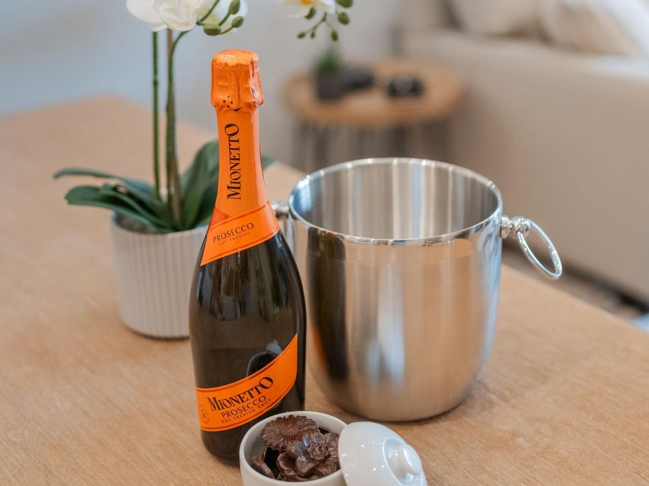 Bottle of Mionetto Prosecco with a chocolate and an ice bucket offers in Canmore hotel deals at Spring Creek Vacations