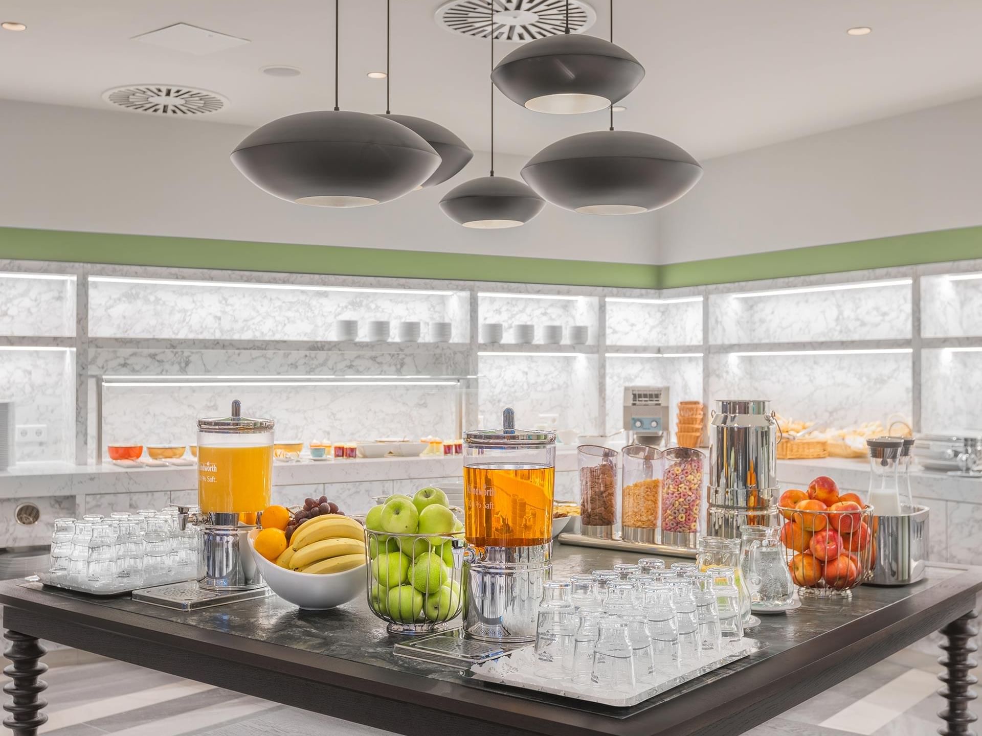 Buffet Breakfast setup with drinks and fruits in Breakfast Restaurant at Titanic Comfort Kurfürstendamm