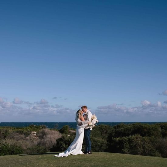 Couple posing by the stunning view of ocean near Pullman Magenta Shores