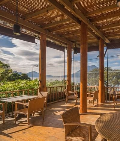 A serene patio overlooking the lake adorned with comfortable chairs at Porta Hotel Del Lago