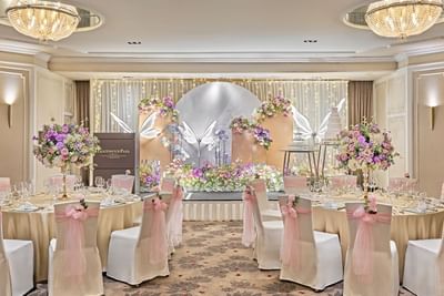 A grand and elegant wedding reception set up in a ballroom at Goodwood Park Hotel with a butterfly floral theme