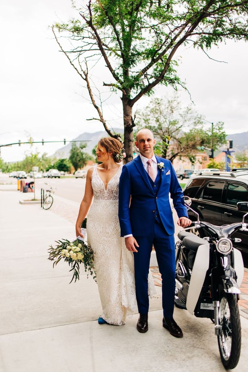 Wedding Couple posing with a scooter near Kinship Landing