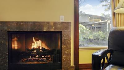 lounge area with chair, fireplace and window